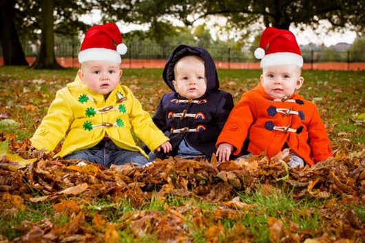 three babies sat in autumn leaves wearing Cololo fun and colourful babyswear jackets
