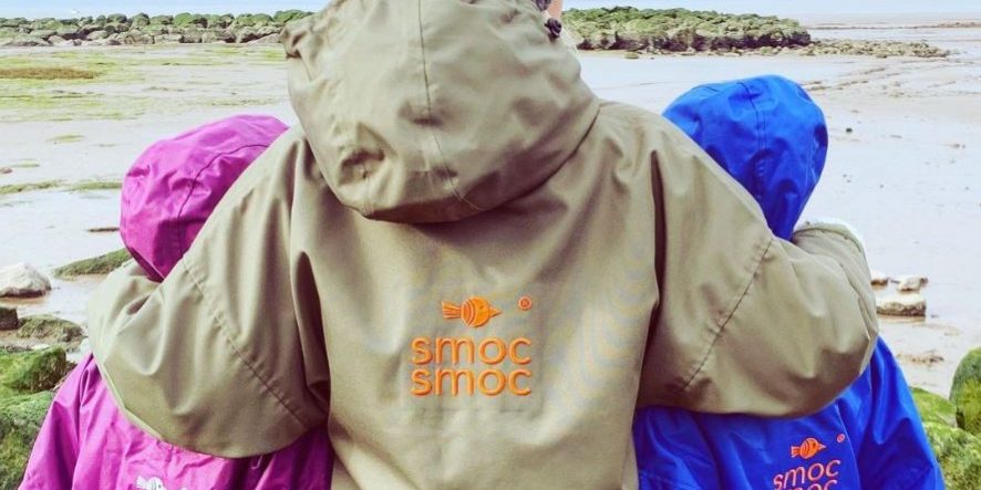 Smoc Smoc clothing - image of people wearing the smocs at a beach