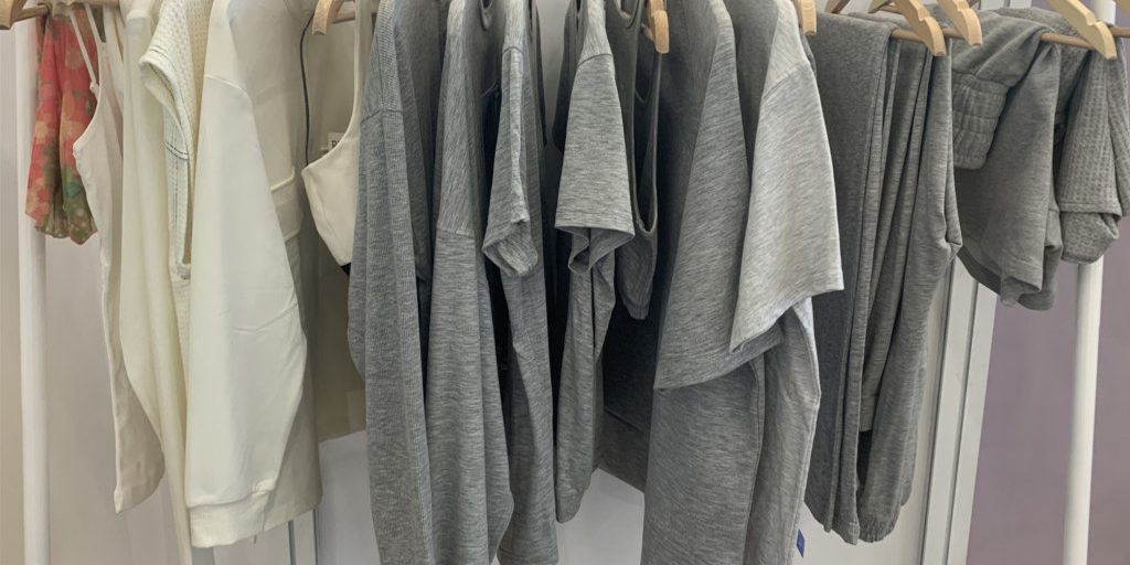 rack of tshirts and other clothing - grey and cream