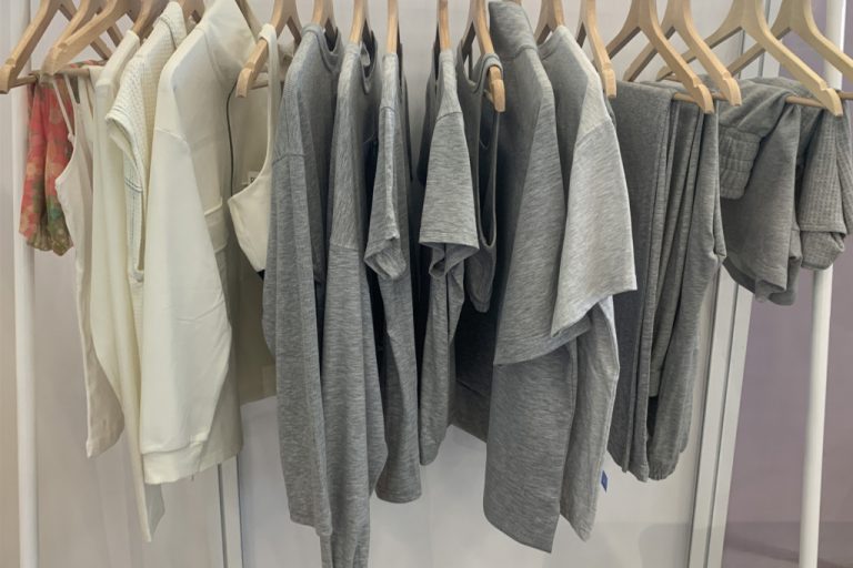 rack of tshirts and other clothing - grey and cream