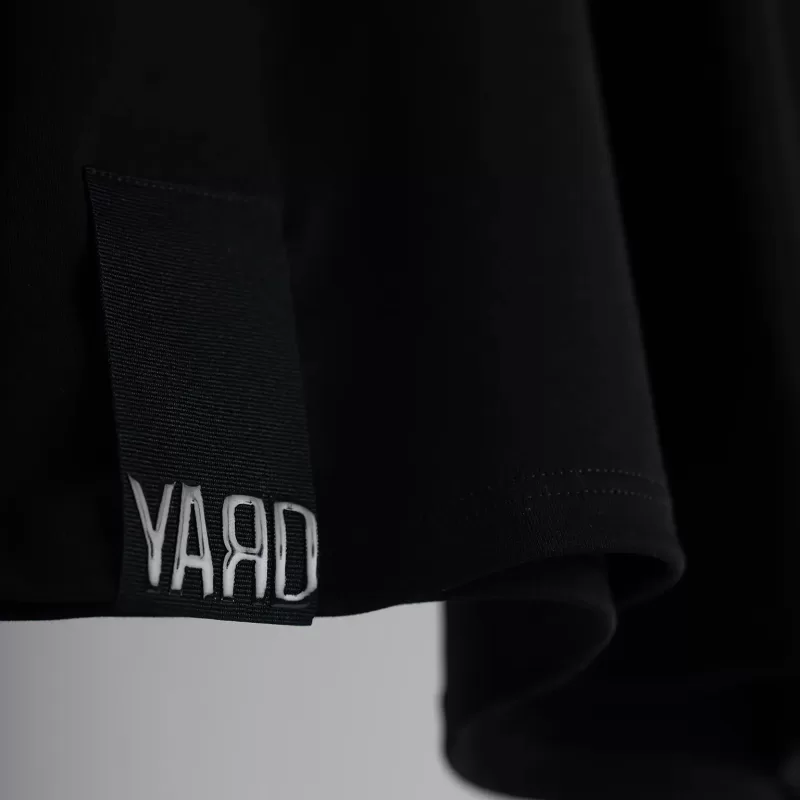 Black t-shirt with cotton twill hem label with "YARD" silicone logo black on black